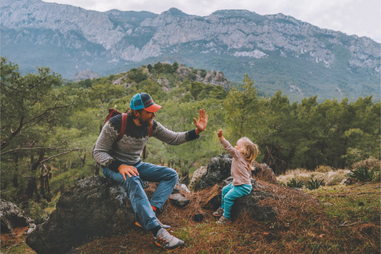 father and child high-five outdoors Adobe adventure